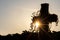 Glowing cross silhouette with sunbeams sunset sunlight and clear evening sky shows christianity spirituality of church and forgive