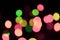 glowing defocused multicolored new years lights on dark blurred background