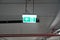 Glowing Emergency exit sign with left arrow at a building. Safety first concept. Copy space wallpaper. Exit signs with light in a