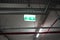 Glowing Emergency exit sign with left arrow at a building. Safety first concept. Copy space wallpaper. Exit signs with light in a