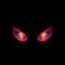 Glowing evil eyes on black background - angry Halloween monster eyes
