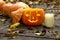 Glowing evil Halloween pumpkin on wooden old floor with dry autumn leaves