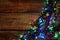 Glowing festive lights on wooden table, top view. Space for text