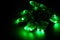 Glowing green led pixels christmas holiday lights on black background