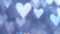 Glowing heart shaped lights sparkling on soft blue background. Romantic Valentine`s day background