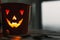 Glowing Jack-o-lantern head in dark. Happy Halloween. Jack o lantern glowing face pumpkin on black background. Trick or treat.