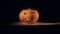 Glowing jack-o-lantern standing on a surface in a dark room