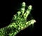 Glowing kirlian aura photography with green corona of a male human hand