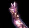 Glowing kirlian coronal aura photography with blue and purple colors of a male human hand