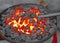 Glowing lava in the grate of the blacksmith during the making of