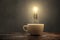 Glowing light bulb above a coffee cup
