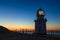 Glowing lighthouse against the night scenery.