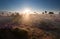 Glowing misty sunrise on dune with heather