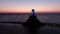 Glowing Moai statue on the beach, colorful sunset sky on the horizon, 4k