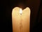Glowing mourning candle in darkness.