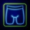 Glowing neon Cycling shorts icon isolated on blue background. Vector