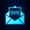 Glowing neon Envelope icon isolated on brick wall background. Received message concept. New, email incoming message, sms