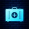 Glowing neon First aid kit icon isolated on brick wall background. Medical box with cross. Medical equipment for
