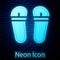 Glowing neon Flip flops icon isolated on brick wall background. Beach slippers sign. Vector