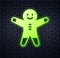 Glowing neon Holiday gingerbread man cookie icon isolated on brick wall background. Cookie in shape of man with icing