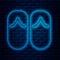 Glowing neon line Flip flops icon isolated on brick wall background. Beach slippers sign. Vector