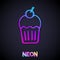 Glowing neon line Muffin icon isolated on black background. Vector