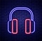 Glowing neon line Noise canceling headphones icon isolated on brick wall background. Headphones for ear protection from