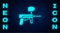 Glowing neon Paintball gun icon isolated on brick wall background. Vector Illustration