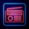 Glowing neon Radio with antenna icon isolated on blue background. Vector Illustration