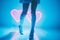 Glowing neon shaped hearts lights with slender model legs and shoes - generative AI