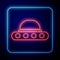 Glowing neon UFO flying spaceship icon isolated on blue background. Flying saucer. Alien space ship. Futuristic unknown
