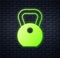 Glowing neon Weight icon isolated on brick wall background. Kilogram weight block for weight lifting and scale. Mass