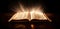 glowing open bible. opened book laying on a wood table.