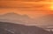 Glowing orange sunlight over silhouettes of Velka Fatra peaks