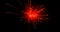 Glowing red firework exploding on black background with defocussed blue spots