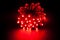 Glowing RED led pixels christmas holiday lights on black background