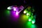 Glowing RGB led pixels christmas holiday lights on black background