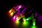 Glowing RGB led pixels christmas holiday lights on black background