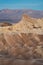 Glowing Rocks at Zabriskie Point with Mountains in the Background During Sunrise, Death Valley National Park, California