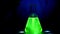 A glowing Science lab for kids with fluorescent green liquid inside of a conical flask.