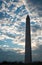 Glowing silhouette of Washington Monument in Washington D.C. at sunset with clouds in background