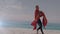 Glowing spot of light against father and son in superhero costume on a beach