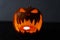 Glowing and terrified halloween pumpkin with a candle inside. Smiling Jack O` Lantern