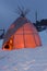 Glowing tipi tent in the snow