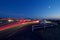 Glowing trails of car lights illuminate parking lot at view point on top of Mount Tolmie