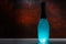 Glowing turquoise blue glass bottle or lamp