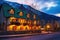 glowing windows of a warm mountain inn at twilight