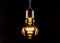 Glowing yellow incandescent lamp on a black background. 3D rendering and 3D illustration