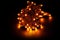 Glowing yellow led pixels christmas holiday lights on black background