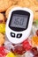 Glucometer with bad result of sugar level and candies with cookies, reduction eating sweets concept